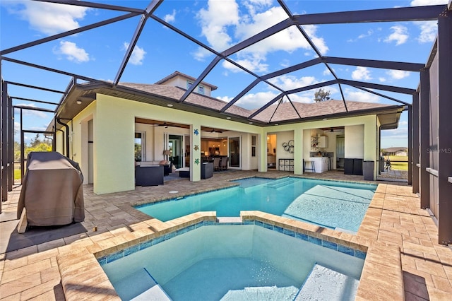 view of swimming pool with a patio area, a pool with connected hot tub, a grill, and an outdoor hangout area