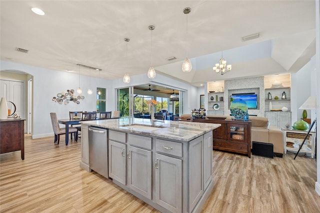 kitchen featuring light wood-style flooring, a sink, visible vents, stainless steel dishwasher, and gray cabinets