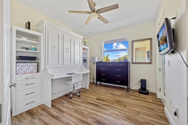 office area featuring ceiling fan, light wood-type flooring, and baseboards