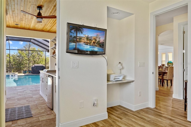 interior space featuring baseboards, arched walkways, lofted ceiling, wood ceiling, and wood finished floors