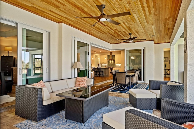 view of patio with a ceiling fan, outdoor dining space, and an outdoor hangout area