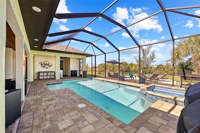 view of swimming pool with glass enclosure, a pool with connected hot tub, and a patio area