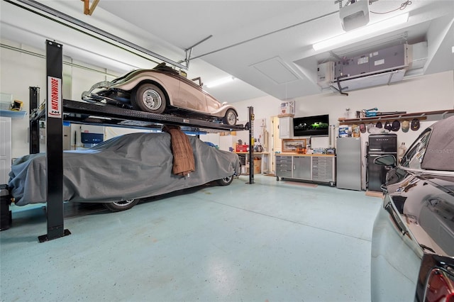 garage with a garage door opener and freestanding refrigerator