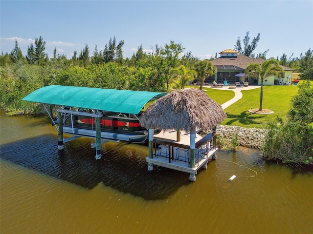 dock area featuring glass enclosure, a water view, and a lawn