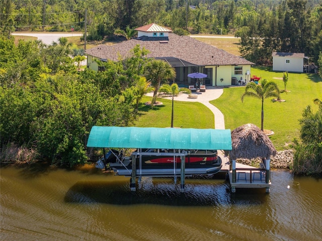 dock area featuring a patio area, a yard, a water view, and boat lift