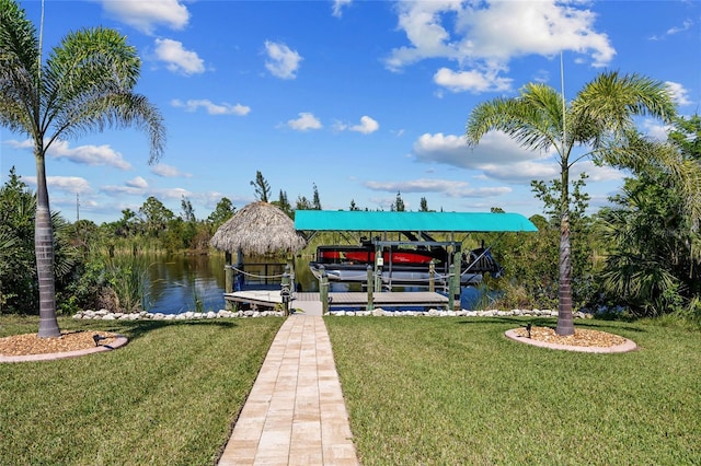 dock area featuring boat lift and a yard