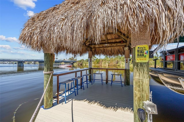 view of dock with a water view and a gazebo