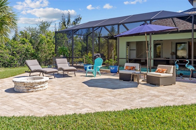 view of patio featuring an outdoor fire pit and a lanai