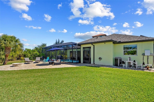 rear view of property with an outdoor fire pit, a lanai, a yard, stucco siding, and a patio area