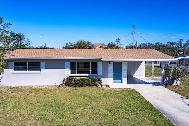 single story home with roof with shingles, driveway, brick siding, and a front lawn