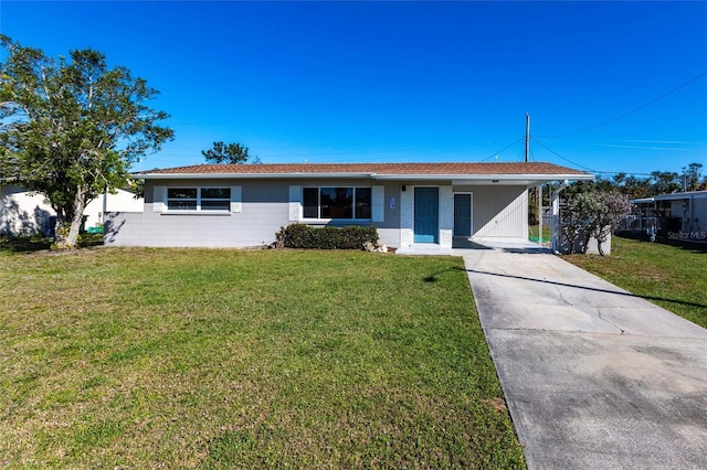 ranch-style home with a carport, concrete driveway, and a front yard