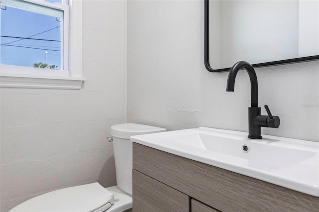 bathroom featuring toilet and vanity