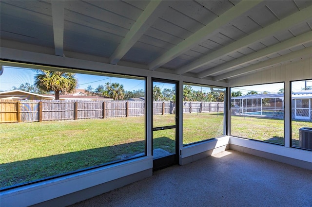 unfurnished sunroom featuring vaulted ceiling with beams