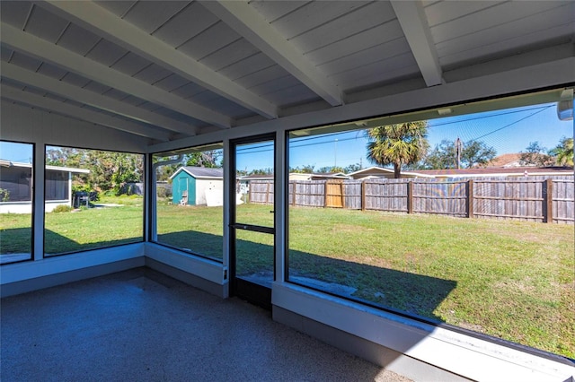 unfurnished sunroom featuring wood ceiling and lofted ceiling with beams