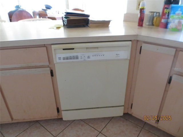 interior space with light countertops, white dishwasher, and light tile patterned flooring