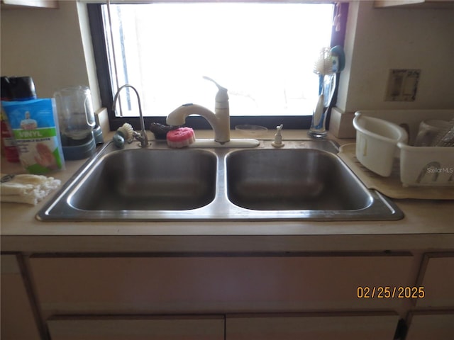 room details featuring light countertops and a sink