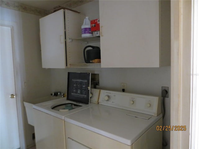 washroom with cabinet space and washing machine and clothes dryer