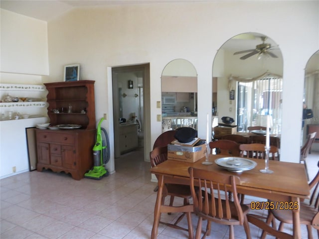 dining area featuring light tile patterned floors, ceiling fan, and vaulted ceiling