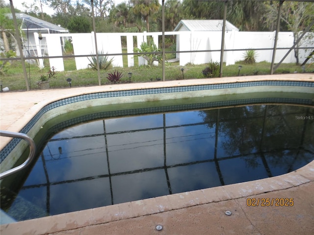 pool featuring a lanai and fence