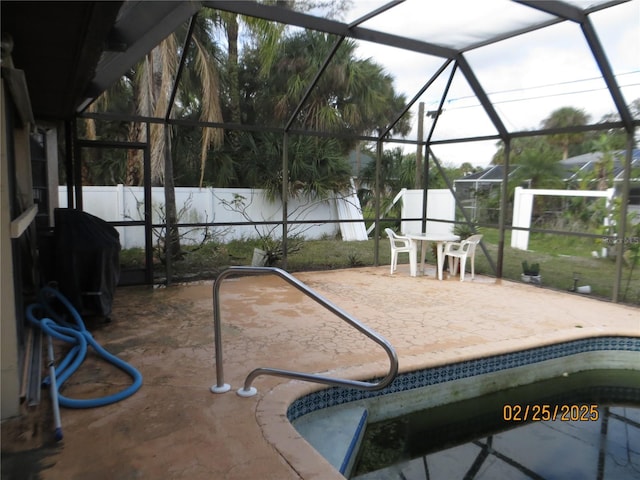 view of patio with glass enclosure, a fenced backyard, and a fenced in pool