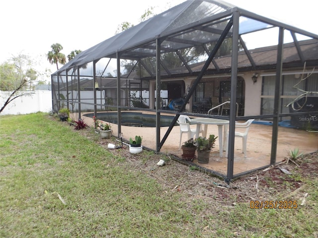 view of swimming pool featuring glass enclosure, a yard, a fenced in pool, and a patio