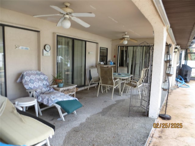 view of patio with outdoor dining area and a ceiling fan