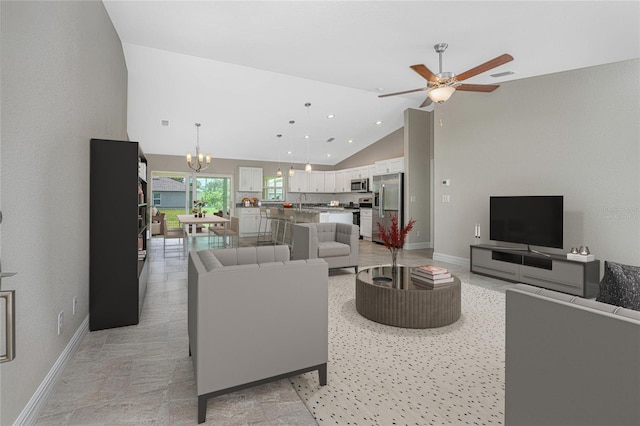 living area with high vaulted ceiling, recessed lighting, ceiling fan with notable chandelier, visible vents, and baseboards