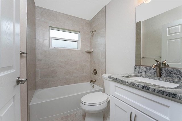 bathroom featuring tile patterned flooring, tub / shower combination, vanity, and toilet