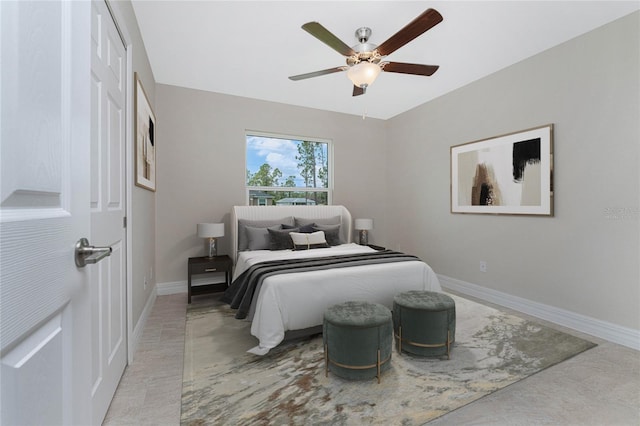 bedroom with ceiling fan and baseboards