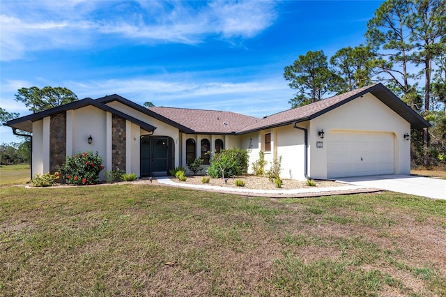 view of front of house with an attached garage, driveway, stone siding, stucco siding, and a front lawn