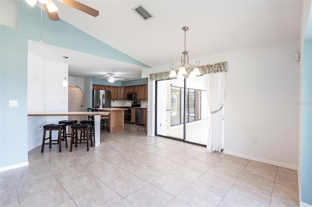 dining room featuring lofted ceiling, arched walkways, ceiling fan with notable chandelier, visible vents, and baseboards