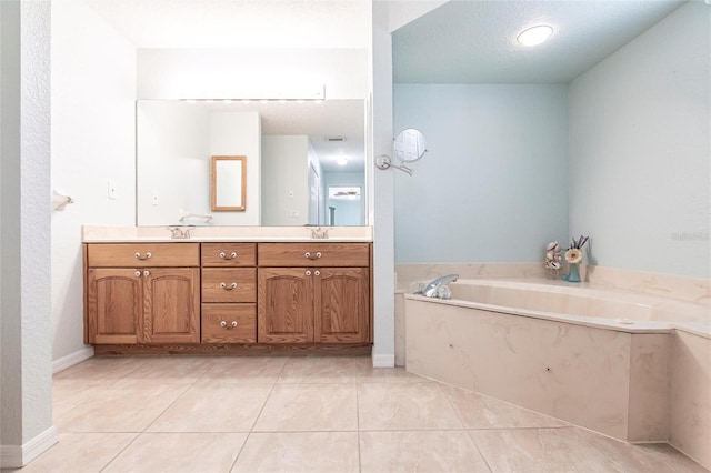 bathroom featuring double vanity, tile patterned flooring, a sink, and a bath