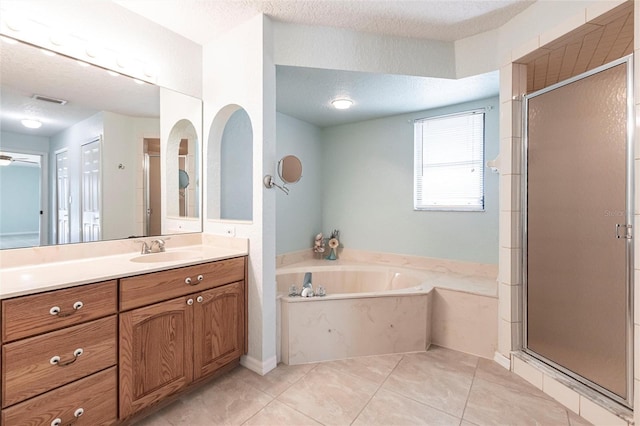 full bathroom featuring a stall shower, a textured ceiling, and a bath