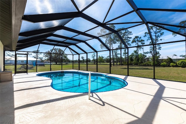 pool featuring a lanai, a patio area, and a lawn