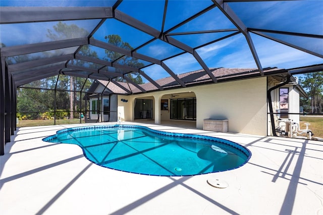 pool featuring a lanai, a ceiling fan, and a patio