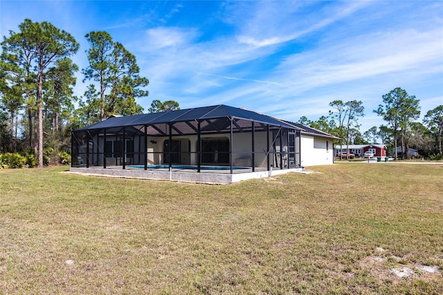 back of house with glass enclosure, an outdoor pool, and a lawn