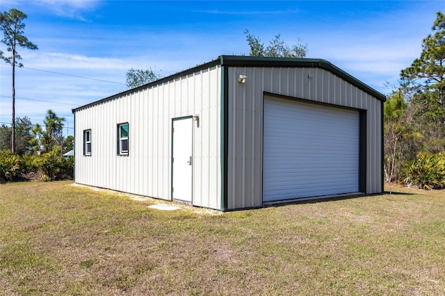 view of outbuilding with driveway and an outdoor structure