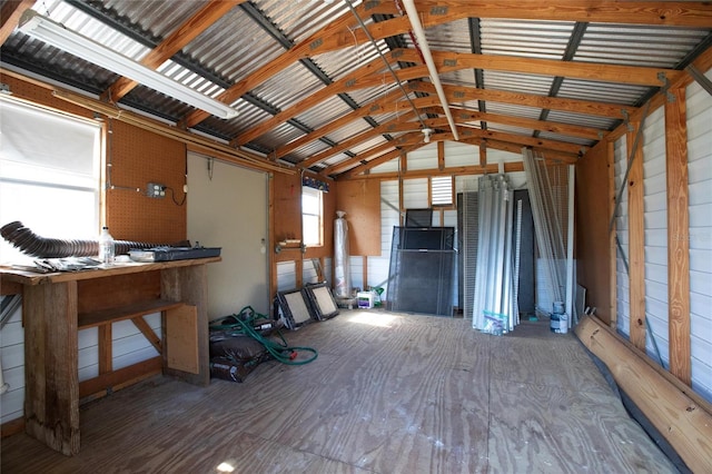 misc room featuring metal wall and vaulted ceiling