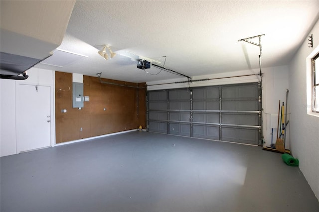 garage with electric panel and a garage door opener