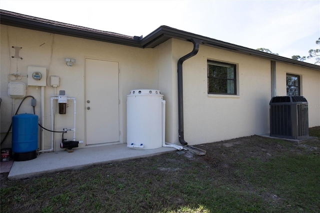 exterior space with central AC unit and stucco siding