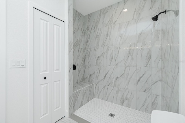 bathroom featuring a closet, toilet, and a stall shower