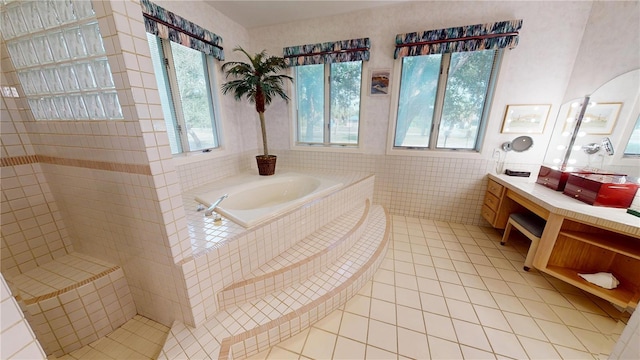 full bathroom with a garden tub, tile walls, vanity, tile patterned flooring, and tiled shower