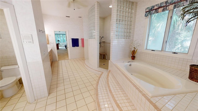 full bath with a stall shower, toilet, a garden tub, tile patterned flooring, and tile walls