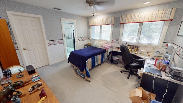 bedroom featuring wallpapered walls, visible vents, a ceiling fan, and light colored carpet