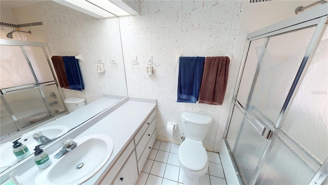 full bathroom with toilet, tile patterned flooring, vanity, and a shower with shower door