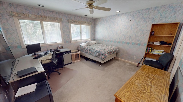 bedroom with light colored carpet, ceiling fan, baseboards, and wallpapered walls