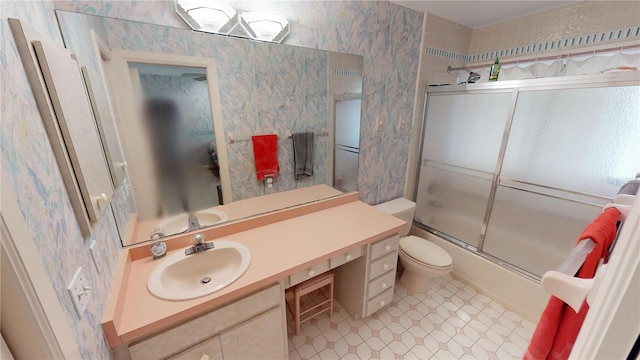 full bathroom featuring toilet, shower / bath combination with glass door, vanity, and wallpapered walls