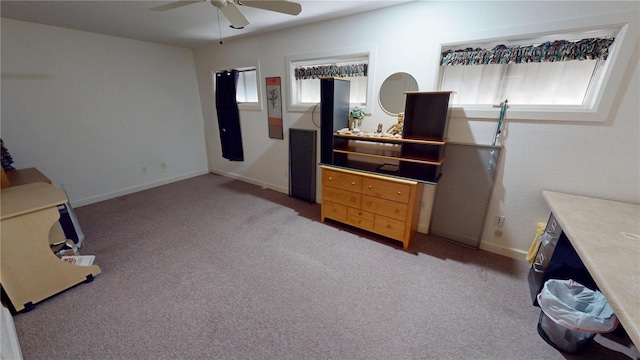 bedroom with light carpet, ceiling fan, and baseboards