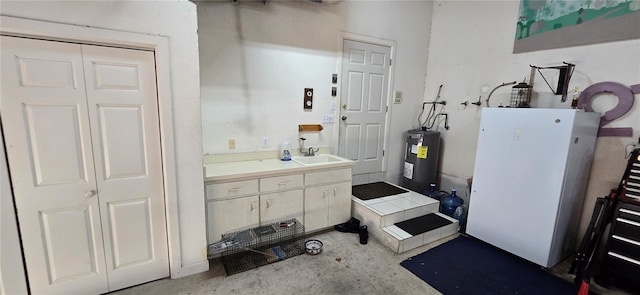 bathroom featuring electric water heater, unfinished concrete flooring, and a sink