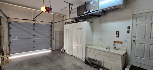 garage featuring a sink and a garage door opener